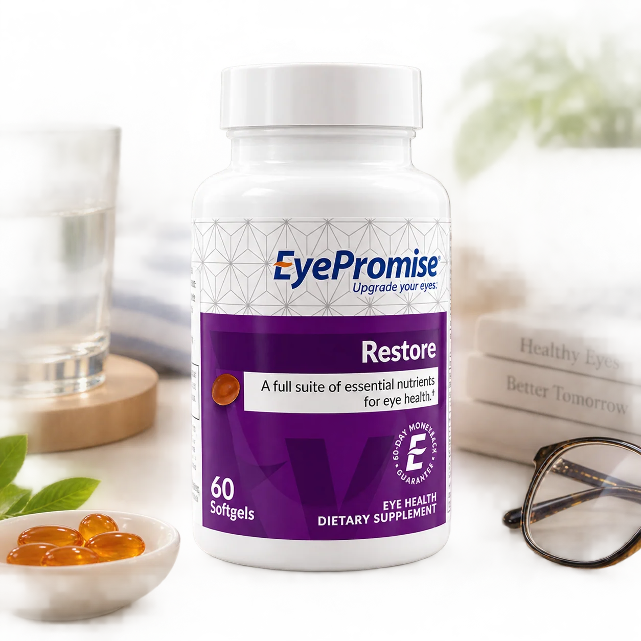 A bottle of EyePromise Restore dietary supplement softgels, set on a white surface with a glass of water, a small bowl of orange gummies, and a pair of eyeglasses in a softly blurred background.